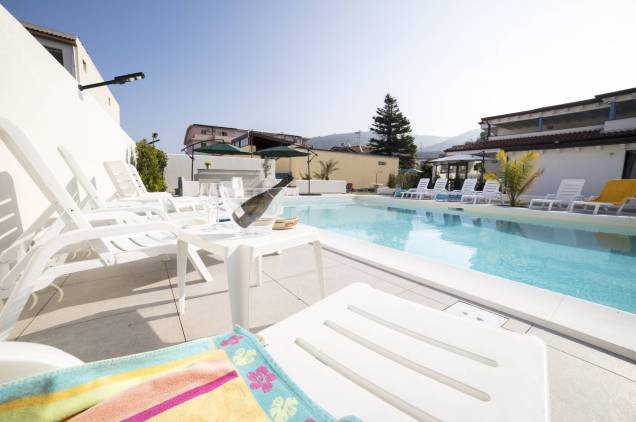 Sun loungers by the pool during an aperitif